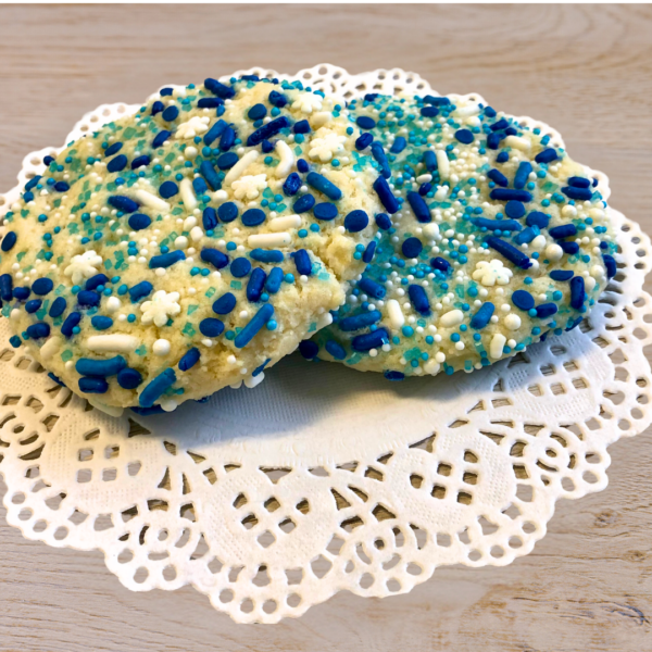 Blue and white sprinkled cookies on lace doily