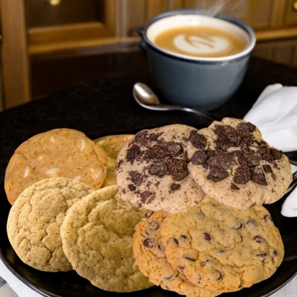 Assorted cookies on plate with hot coffee cup