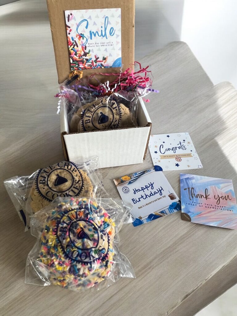 Assorted cookies with celebration cards on table