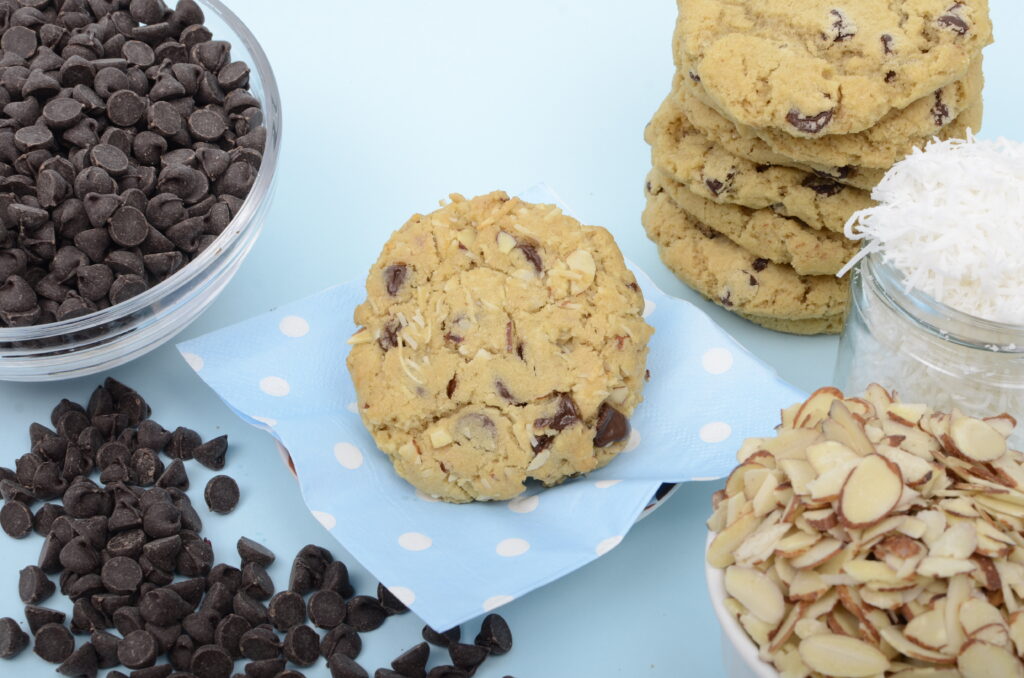 Chocolate chip cookies with ingredients on a blue background
