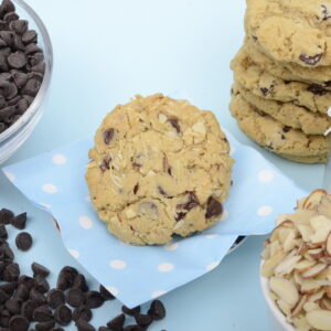 Chocolate chip cookies with ingredients on a blue background