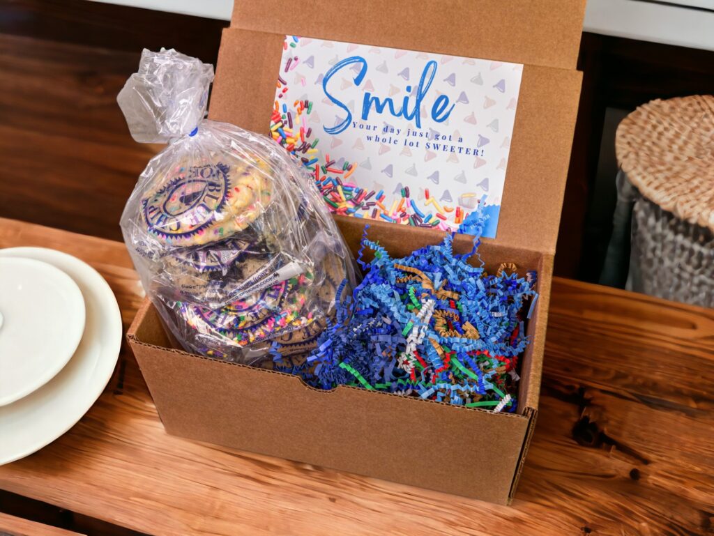 Colorful frosted cookies in box with 'Smile' card