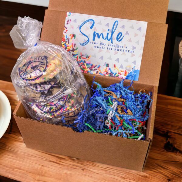 Colorful frosted cookies in box with 'Smile' card