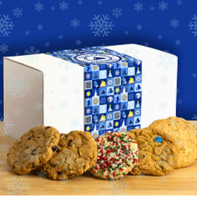 Festive cookies in front of a blue snowflake-patterned gift box