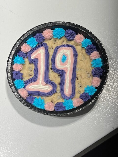 Decorative 19th birthday cookie cake with colorful frosting